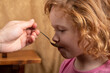 © Fukume - little girl 4 years old drinks cough syrup from a spoon,the child is taking medication