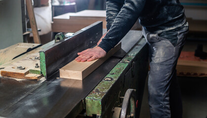 Poster - Professional carpenter milling the wood on the  huge saw for a modern furniture, joinery and woodwork concept