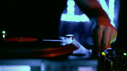 Wall Mural - Dj playing music with vinyl records and turntable on rave party in nightclub.Professional disc jockey audio equipment on concert stage in neon lights.