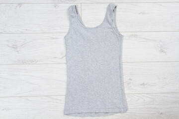 Wall Mural - Blank grey Tank Top fold Shirt Mock-up for man on wooden background, tank mock up