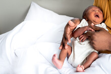 Portrait Images Of African Black Skin , 12-day-old Baby Newborn Son, Sleeping With His Father Being Held In White Bed, To Family And African Infant Newborn Concept.