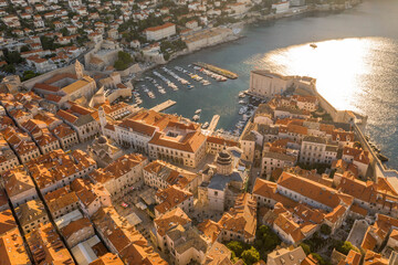 Wall Mural - Aerial drone shot of Dubrovnik old town port in sunrise sun light in Croatia summer