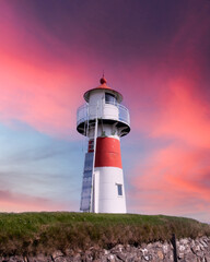 Wall Mural - Old lighthouse outside Torshavn city against incredible purple sunset sky, Streymoy island, Faroe Islands, Denmark