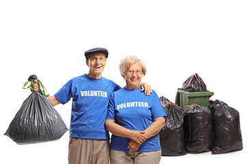 Poster - Elderly volunteers posing in front of dust bins with plastig waste bags