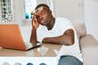 © SHOTPRIME STUDIO - man african appearance at home in front of laptop work technology