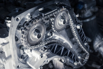 new car timing chain on a disassembled diesel old engine in a car workshop. close up. blur effect.