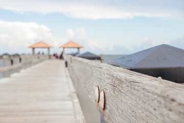 Seascape. Wooden pier with gazebos with orange roofs. Summer background. Ken Combs Pier, Gulfport, MS, USA