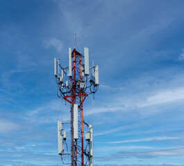 Wall Mural - Telecommunication tower of 4G and 5G cellular. Macro Base Station. 5G radio network telecommunication equipment with radio modules and smart antennas mounted on a metal against blue sky background.