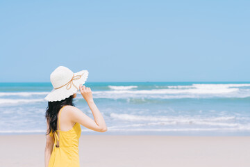 Young Asian woman enjoying summer vacation on the beach