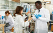 © JackF - Serious man and woman lab technicians discussing about results during performing experiments