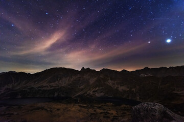 Wall Mural - Starry nights in the High Tatras with a tourist in a tent on top	