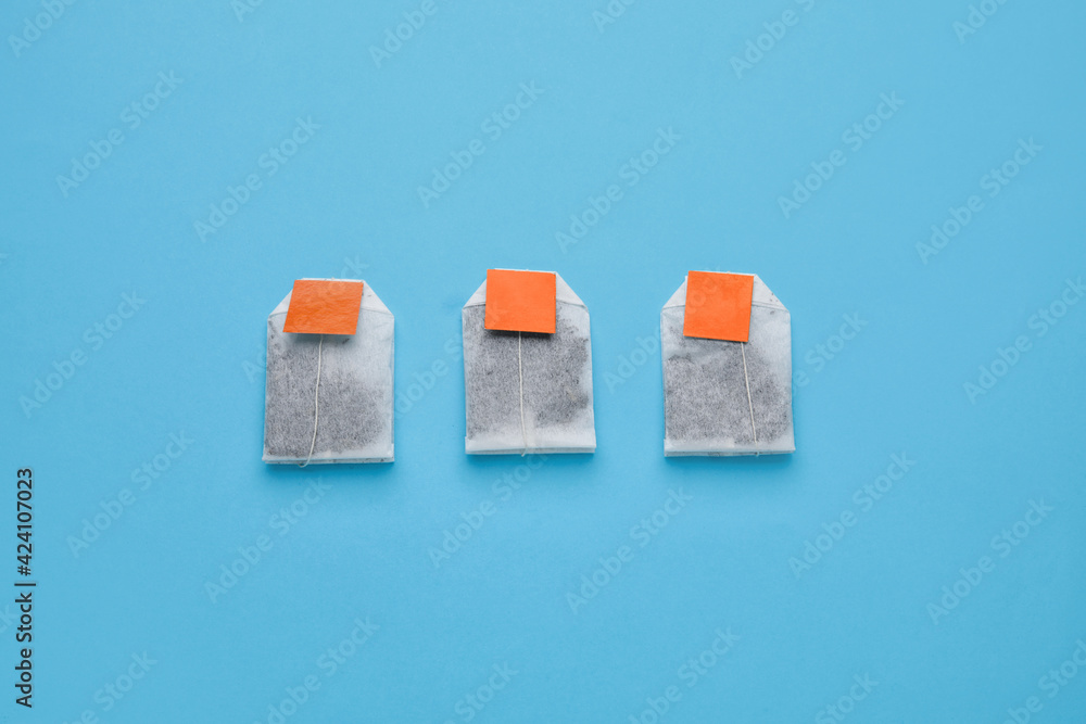 Tea bags on color background