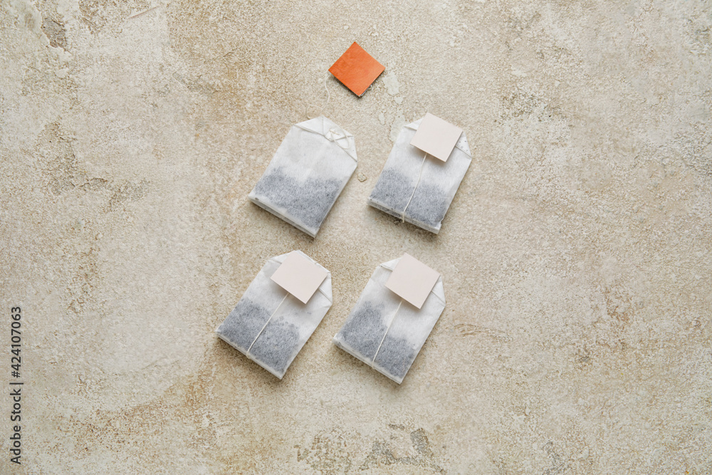 Tea bags on light background
