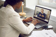 © Studio Romantic - Young employee having online work meeting with senior boss, over shoulder view. Two multiethnic business people discussing current project via video call. Virtual communication and remote job concept