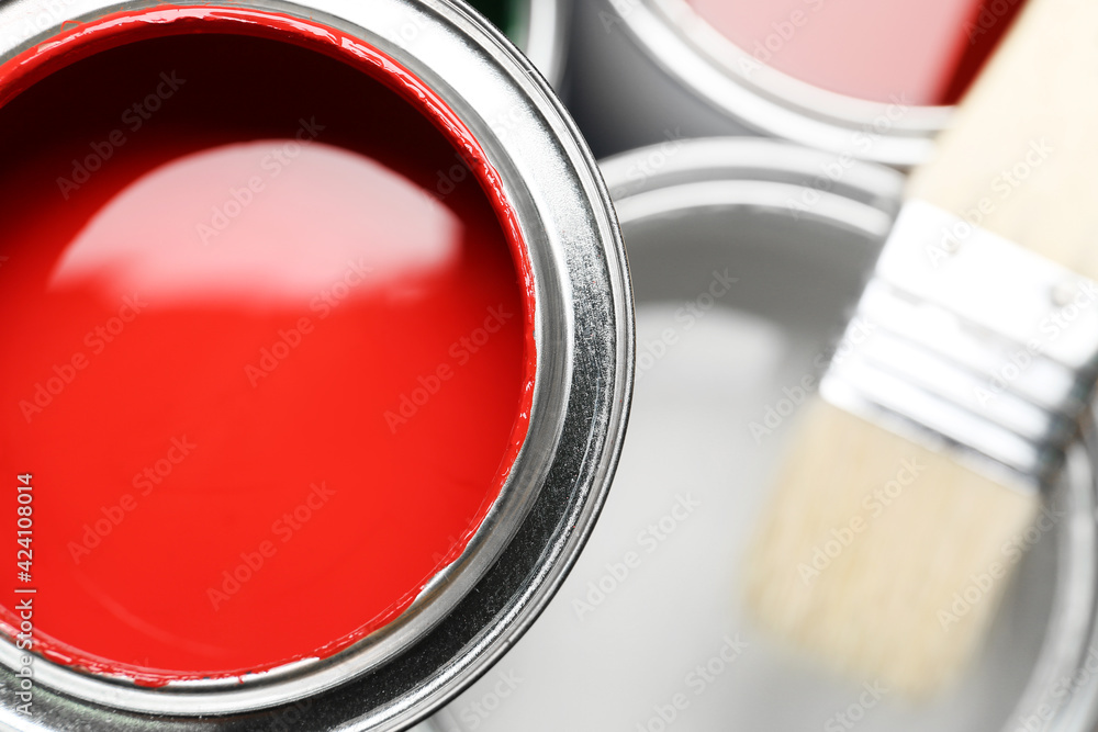 Can of red paint and brush, closeup
