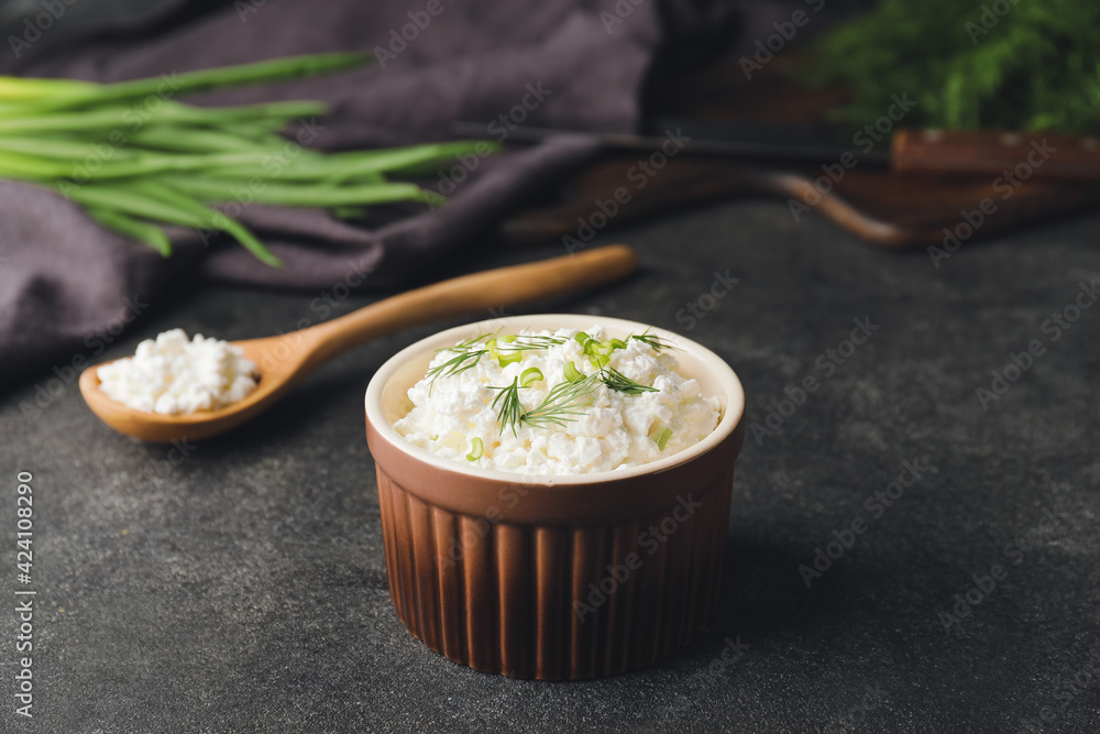 Bowl with cottage cheese on dark background
