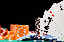 Poker Chips And Playing Cards On Black Background
