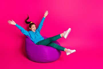 Poster - Full length photo of sweet cute woman dressed hoodie rest purple bean bag looking empty space isolated pink color background