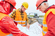 © Robert Kneschke - Construction workers discuss blueprint of house building