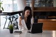 © Natee Meepian - Shot of an attractive young businesswoman working on laptop in her workstation