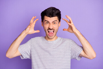 Wall Mural - Photo of young angry furious mad aggressive man screaming having conflict trouble isolated on violet color background