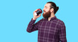 © Vulp - Photo of handsome bearded hipster man drinking coffee over white background