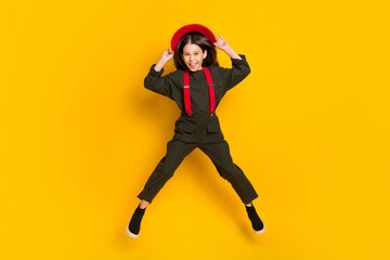 Poster - Full length body size view of attractive cheerful funky girl jumping having fun isolated over bright yellow color background