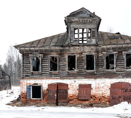 Old wooden destroyed russian house ruined made of wood and bricks