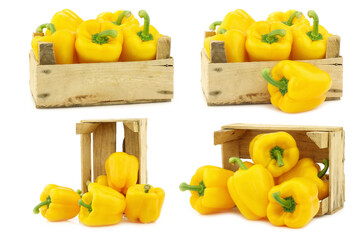 Wall Mural - fresh yellow bell peppers (capsicum) a in a wooden crate on a white background