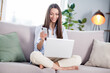 © deagreez - Full size photo of nice hooray brunette long hairdo lady sit look telephone laptop on coach wear shirt at home