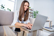 © deagreez - Photo of happy smiling lovely beautiful woman sit sofa couch at home remote working in laptop computer