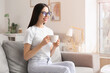 © Pixel-Shot - Young woman drinking coffee at home