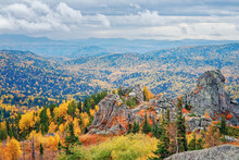 View Of The Rocks Under The Clouds, Mountainous Colorful Taiga With Autumn Withered Grass High In The Mountains Among The Stones In Kolyvan, Altai