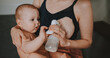 © Алина Троева - Young mother with newborn cute infant naked baby boy, holding him on arms, using breast pump hugging and breastfeeds with breast milk. Healthy child, concept of hospital and happy motherhood. Nursery.