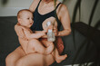 © Алина Троева - Young mother with newborn cute infant naked baby boy, holding him on arms, using breast pump hugging and breastfeeds with breast milk. Healthy child, concept of hospital and happy motherhood. Nursery.