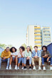 © gpointstudio - Portrait of young group of friends sitting on the stairs