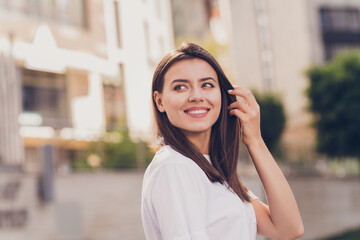 Wall Mural - Photo portrait of pretty girl wearing white t-shirt walking on summer streets smiling looking at side