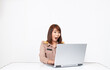 © pichest - Female thai teacher in uniform sitting with white background using computer