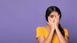 Portrait of shocked young indian woman covering eye