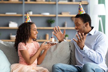 Wall Mural - Beautiful black girl holding birthday cake for her dad