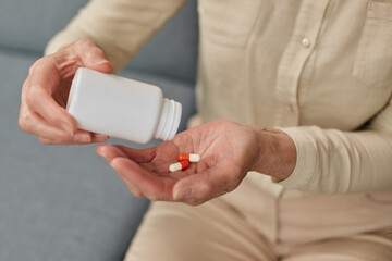 Wall Mural - Senior woman taking daily medications at home during illness