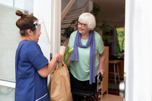Home Carer Bringing Senior Woman Shopping