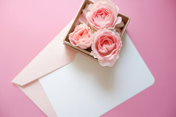 Spring greeting concept. Pink roses gift box with blank greeting card on pink background. Wedding, Bridal, Mother's day and Birthday. ピンク薔薇とカード、結婚式、母の日、誕生日のデコレーション背景