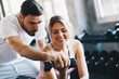 © themorningglory - Sporty couple make weight lifting together in loft gym