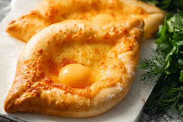 two Adjarian khachapuri in traditional classic Georgian style.