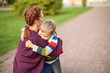 © candy1812 - Child with rucksack and with mother infront of a school building