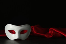 White Theatre Mask And Red Fabric On Black Background, Space For Text