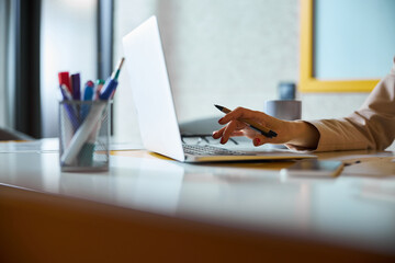 Close up of female person working at computer