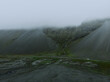Aerial drone view of beautiful nature dramatic landscape in Iceland. Low clouds, fog on the mountains. Cold toned filter