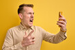 Young Angry Male Screaming At Mobile Phone Camera While Talking On Phone